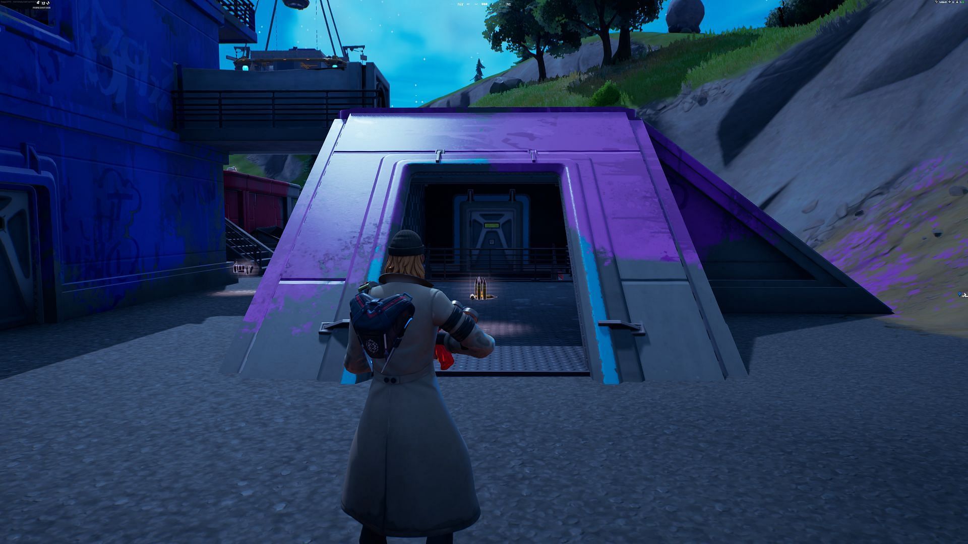 Look for the building covered in pink/purple paint (Image via Epic Games/Fortnite)